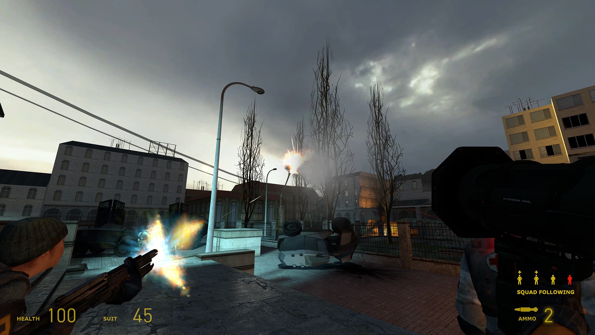 A screenshot from Half-Life 2. A rebel fires at a Combine Strider while Gordon Freeman hits it with a rocket from his rocket-propelled grenade launcher.