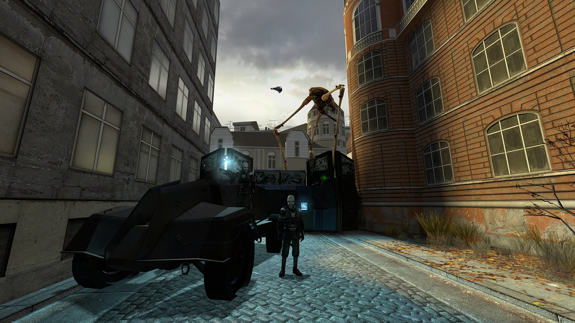 A screenshot from Half-Life 2. Two Civil Protection officers stand guard in front of a checkpoint while, behind them, a Strider thunders past.
