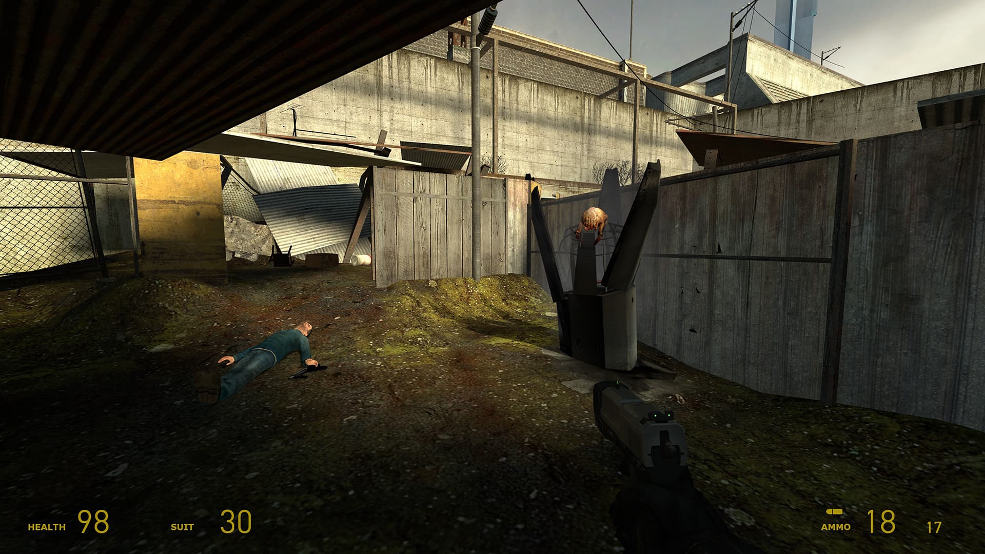 A screenshot from Half-Life 2. In the canals, a citizen lies dead on the ground near a Combine shell, from which a headcrab is climbing out of.