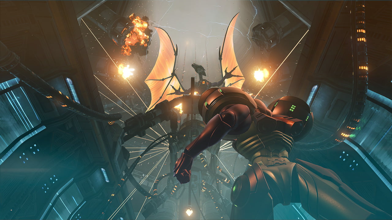 A screenshot from Metroid Prime Remastered. Intergalactic bounty hunter Samus Aran stares up at her nemesis Ridley, reborn in a cybernetic body, as the spaceship around them explodes.