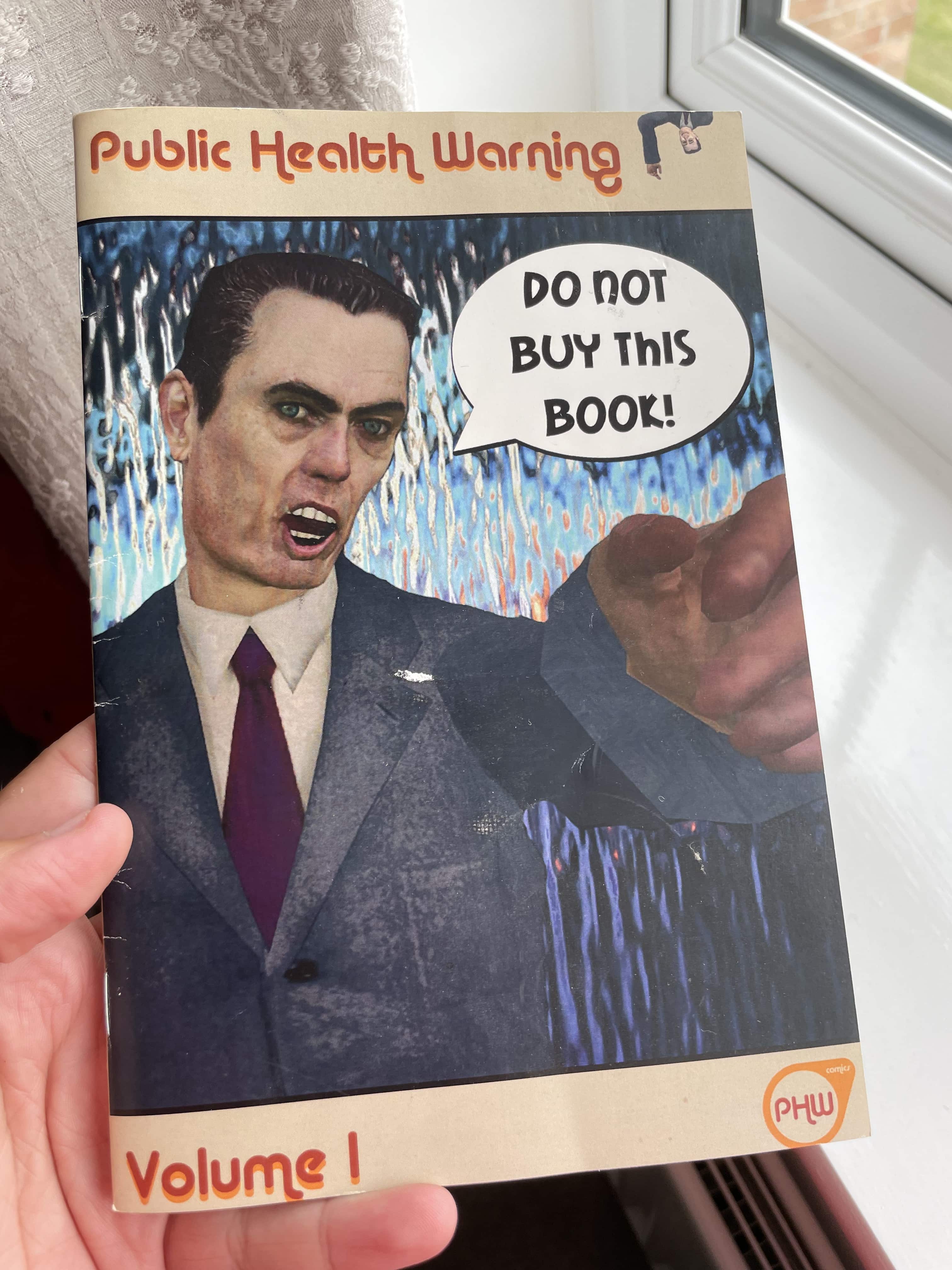 A printed comic book with the G-Man on the cover, telling the reader not to buy the book.