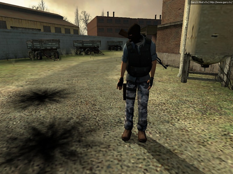 A terrorist looks to the side at the scorch marks of the grenades in the ground. None of them hit even close to him.
